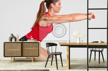 Studio shot of slim sporty woman holding yoga mat before or after
