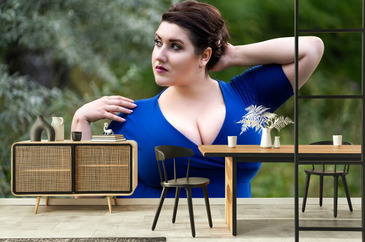 Plus Size Fashion Model in Blue Dress with a Deep Neckline