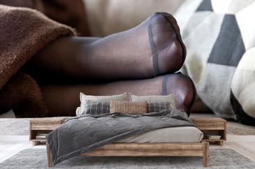 A Close Up Portrait Of The Feet Encased In Pantyhose Of A Person Lying In A  Couch Under A Brown Blanket With A Pillow In The Back. The Color Of The  Nylon