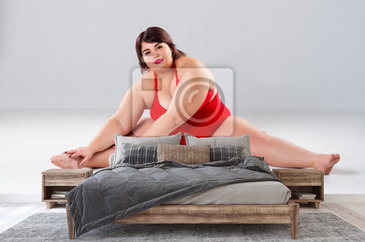 Plus size model in lingerie, fat woman on gray background