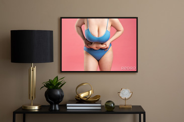 Fat woman with very large breasts in a push-up bra on pink