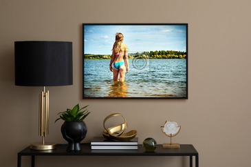 Teenager girl wearing bikini stands in the water of a beautiful