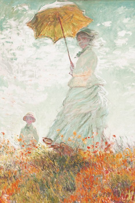 Eine mutter und ihr kind unter einem regenschirm auf einer blühenden wiese