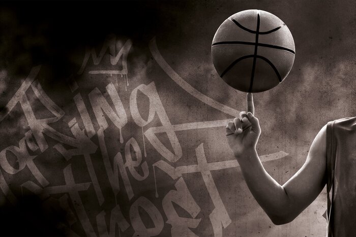 Ein spieler führt einen basketballtrick vor.