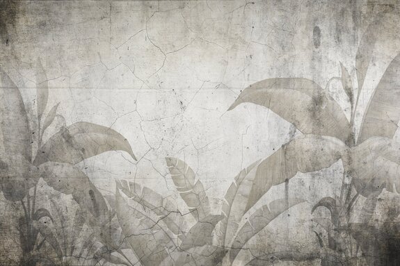 Composition de feuilles tropicales sur un vieux mur fissuré