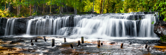 Cascade avec lac et pilotis dans la forêt