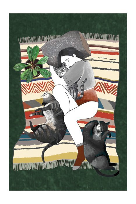 Femme avec des chats sur une couverture douce