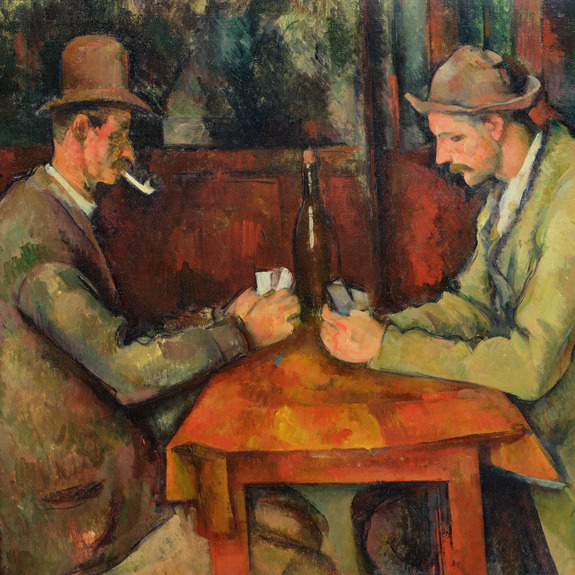 Heren spelen kaarten aan een tafel in een bar