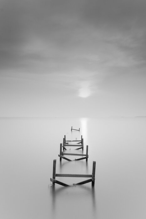 Black and white landscape wooden pier on the sea