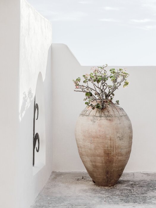 In boho style flower pot with flowers