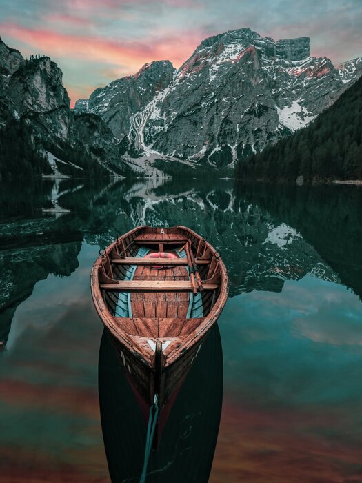 Wooden boat on a lake with mountain landscape in the background